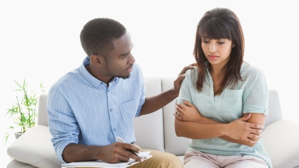 Male places hand on Female Shoulder offering understanding comfort and support.